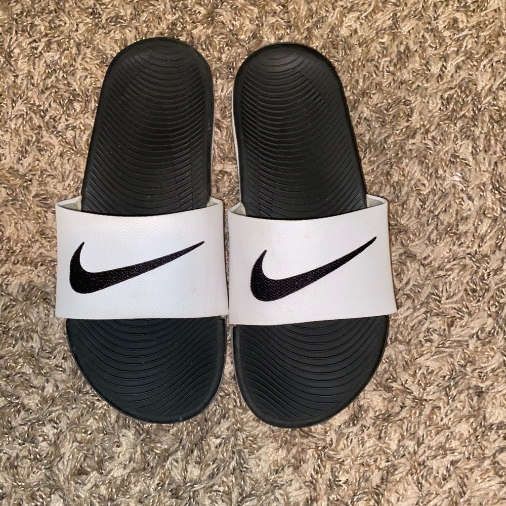 white and black nike slides